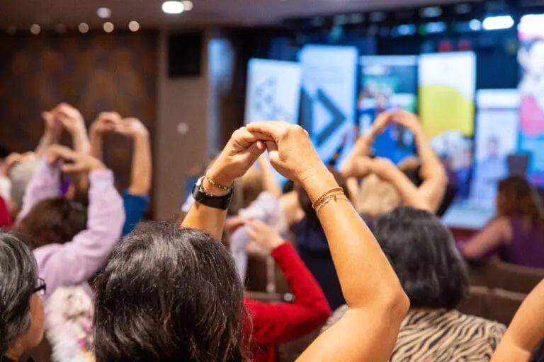 People creating art and connecting in the inclusive Love and Hope Hub community space.