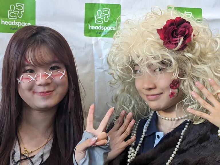 Two youth pose in costume and face paint at a Targeted Early Intervention workshop.