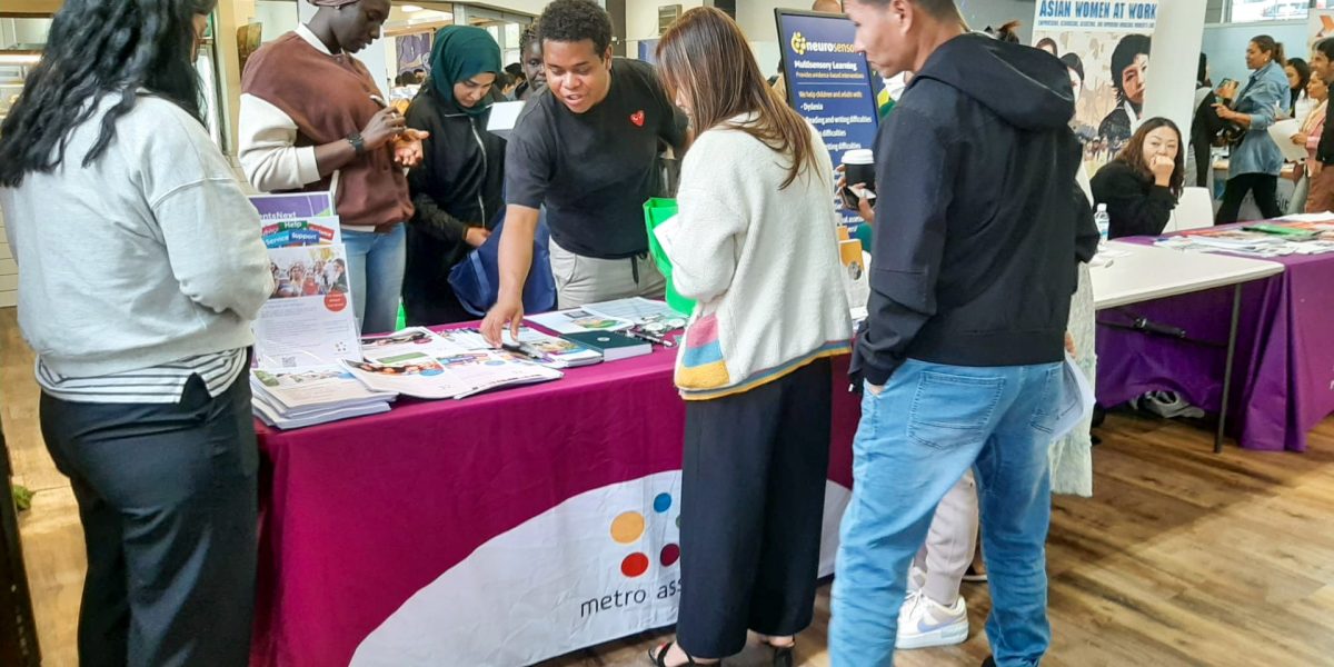 Student Work Placement Opportunities Students speak with Metro Assist staff about work placement opportunities at a career fair.